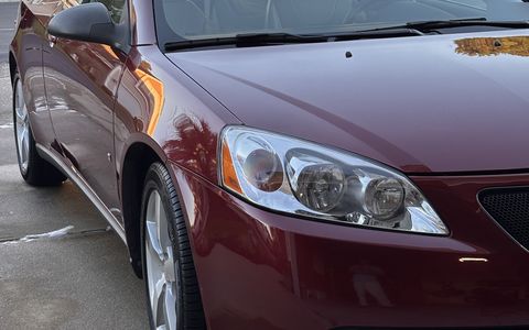Glossy red Pontiac G6 front end with clear headlights after a detail